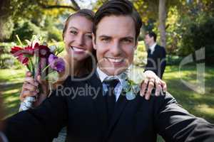 Portrait of happy couple posing in park