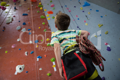 Boy standing with rope in fitness studio