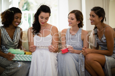 Bride receiving gifts from bridesmaids