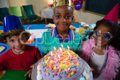 High angle portrait of boy holding birthday cake