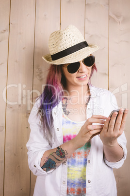 Woman smiling while using mobile phone