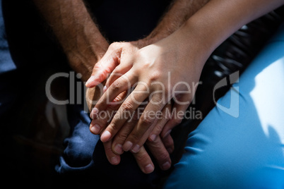 Hands of female doctor consoling senior man in nursing home