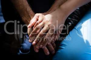 Hands of female doctor consoling senior man in nursing home