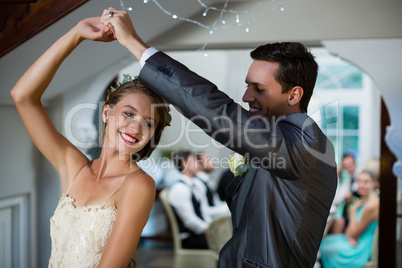 Wedding couple dancing in hall