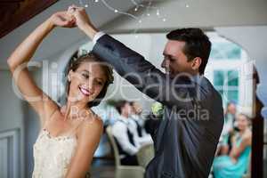 Wedding couple dancing in hall