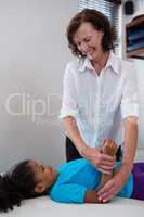 Physiotherapist giving hand massage to a girl patient