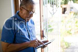 Senior man using digital tablet at nursing home