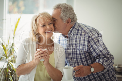 Senior man kissing senior woman