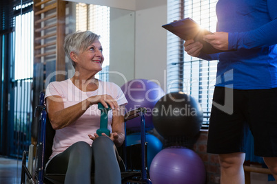 Senior woman interacting with physiotherapist