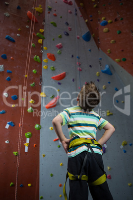 Thoughtful boy looking at wall in fitness studio