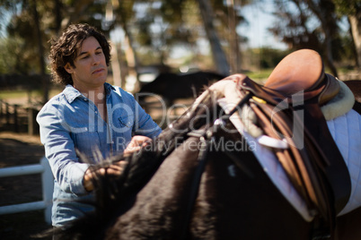 Man standing with horse in the ranch