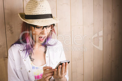 Surprised woman using mobile phone