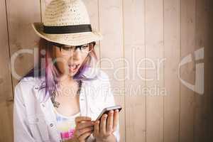 Surprised woman using mobile phone