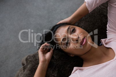 Woman relaxing on bed over floor