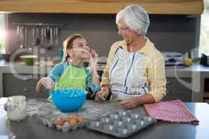 Granddaughter showing eggs to grandmother and smiling