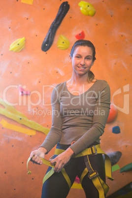 Portrait of confident woman wearing safety harness