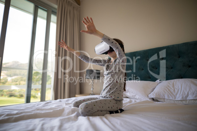 Girl using virtual reality headset on bed