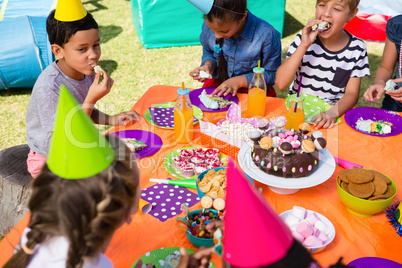 High angle view of children having cake at table