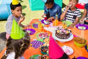 High angle view of children having cake at table