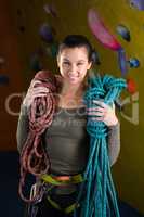 Happy woman with rope in fitness studio