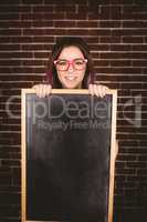 Portrait of smiling woman holding slate