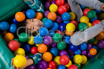 Overhead view of boy in ball pool