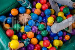 Overhead view of boy in ball pool