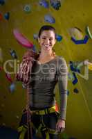 Happy woman with rope in fitness studio