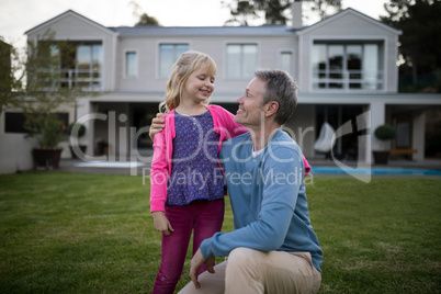 Father and daughter interacting with each other in garden