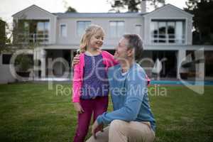 Father and daughter interacting with each other in garden
