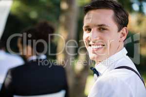 Portrait of happy waiter in park