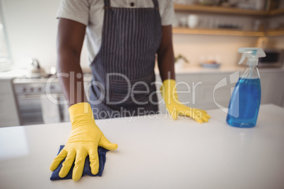 Man cleaning the kitchen worktop