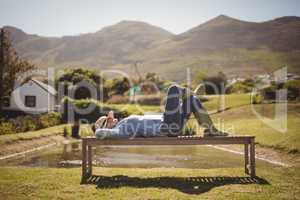 Senior woman sleeping on the park bench