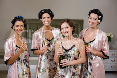 Women holding glasses of champagne at home
