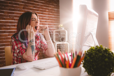 Female executive yawnning at her desk