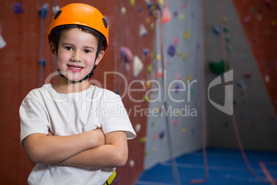 Boy standing with arms crossed in fitness studio