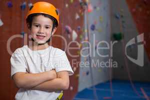 Boy standing with arms crossed in fitness studio