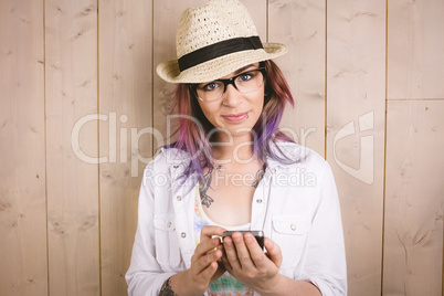 Woman using mobile phone against wooden background