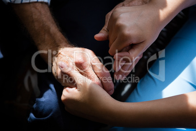 Hands of female doctor consoling senior man in retirement home