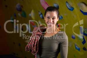 Happy woman with rope in fitness studio