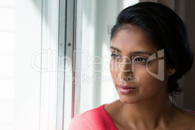 Woman looking through window