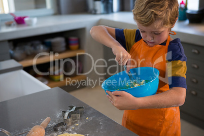 Boy mixing batter in bowl