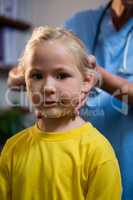 Female doctor examining a little girl