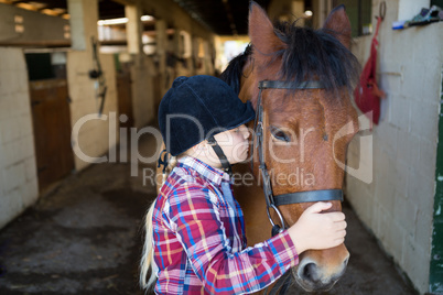 Girl kissing the horse