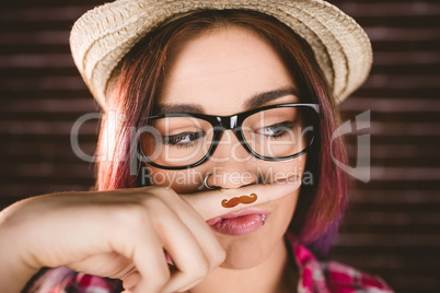 Beautiful woman pretending to have a fake moustache