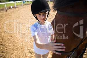 Girl caressing the white horse in the ranch