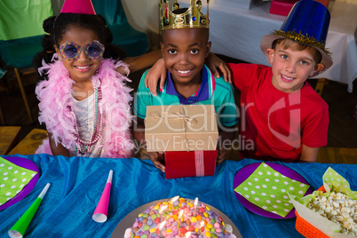 High angle portrait of smiling friends with arms crossed at table