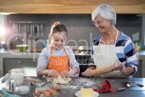 Granddaughter kneading dough