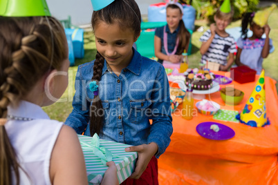 Girl giving gift to friend