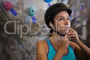 Woman wearing protective helmet in fitness studio